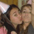Two people wearing party hats kiss, with one person's arm around the other in a close-up shot.