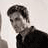 Static grayscale icon of a person with dark hair and a black shirt against light background, pixelated rendering at 256x256 resolution.
