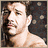 Pixelated image of a shirtless man with short dark hair against a dark background with light speckles, with a second version showing a different pose and background.