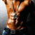 A muscular torso with defined abs, wearing dark pants and a silver chain necklace, shown in a static pose with no visible text or additional props.