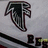 A pixelated black and white icon with a stylized curved shape resembling an arrow or wing, set against a light gray background.