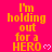 Bright pink background with repeated yellow text 'I'm holding out for a HERO' and small white heart symbols, arranged in a pattern