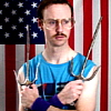 A person in a blue sleeveless shirt stands with arms crossed, holding two wine glasses, against an American flag background.