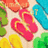 Colorful flip-flops in pink, yellow, green, blue, and orange arranged on a light beige background with subtle shadows.
