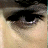 Static close-up of a person's eye with dark eyeliner and subtle makeup on light skin, rendered in low-resolution pixel art style.