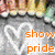 A pixelated image with a blurred background showing indistinct figures and colors, featuring prominent orange text reading 'show pride' in lowercase letters.