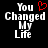 Pixelated text "You Changed My Life" with a red heart symbol replacing the 'o' in You on one side of an animated pair.