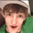 A person with brown hair and a green shirt appears in two side-by-side frames; the right frame displays bright green text over their face.