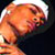 Pixelated close-up of a person's face with warm orange and red tones against dark background, likely from an AOL Instant Messenger buddy icon.