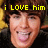 Pixelated image of a person with brown hair and light skin, yellow text above reads 'i LOVE him', background has dark and golden tones.
