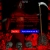 Pixelated red figure with blue and red light bars, holding a scythe-like object against dark background.