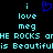 Pixelated cyan text on black background with blue heart symbol, showing 'i love meg' and partial phrases like 'HE ROCKS oME' and 'is Beautifulis'.