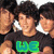 A pixelated image of a person with dark curly hair wearing a black shirt, overlaid with green and blue text that changes across frames.