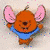 Animated cartoon character with orange fur, pink ears, and blue shirt in three sampled frames showing facial expression changes.