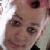 Pixelated close-up of a person's face with visible eyes, nose, and mouth, set against a light background with faint color gradients.
