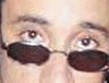 Four distinct cropped portrait images of people with glasses, arranged in a , showing varied facial expressions and clothing