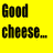 Yellow background with black text 'Good cheese...' above orange text '_comes from happy cows!!!' and a cow head next to a cheese wedge.