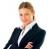 Pixelated image of a person in dark suit with white shirt, light brown hair styled short, neutral expression against plain background.