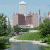 Pixelated cityscape with castle-like structures and waterway on left, green background with 'Original Icons .com' text on right.