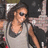 Pixelated image of a woman with dark hair and sunglasses on left, green background with pixelated text phrases.