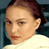 Static 49x49 pixel buddy icon showing a close-up of a person's face with brown hair tied back, wearing a light-colored top against a dark background.