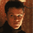 Pixelated static image of a person's face with dark hair and neutral expression against brown background, rendered in low-resolution 48x48 pixels with visible dithering and color blending.