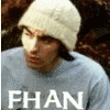 A person wearing a white knit beanie and light blue shirt with the text 'FHAN' displayed across the chest, shown in a of six with color variations on the text