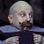 Pixelated static image of a bald man with light skin, dark mustache and beard, wearing blue collared shirt against black background.