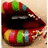 A close-up of lips with colorful horizontal stripes in red, green, blue, and yellow on the lower lip against a light background.