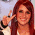 Six pixelated images of a woman with red hair in various poses and outfits, including peace sign gesture, heart symbol on chest, and red cap.