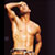 Static pixelated image of a shirtless male figure with raised arm against dark background, rendered in warm tones with visible dithering and low-resolution artifacts.