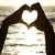 Four distinct heart-shaped hand gestures and a blue 'LOVE' label arranged in a , each with unique background styles
