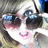 Pixelated image of a person with short hair wearing dark sunglasses and pink lips, with red text overlaid on the right side.