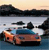 Pixelated image of a car on water with a landscape background, featuring blue, orange, and dark tones.