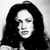 Black-and-white pixelated image of a person with long dark hair, closed eyes, and a neutral expression against a light background.