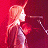 A 48x48 pixel animated buddy icon featuring a cartoon-style female singer with long orange hair singing into a microphone against a red background, paired with green text reading "Original Icons .com" on the right side.