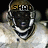 Pixelated static image of a character with dark skin, white teeth, and a helmet displaying 'SHAD' in blocky letters against a black background.