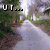 A pixelated road scene with overlaid text fragments, showing a winding path through greenery under bright lighting.