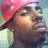 Pixelated close-up of a person wearing a pink cap and dark clothing against a light background with blue tones.
