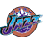 Pixelated circular icon with brown outer ring, blue and purple abstract patterns, white star-like shape at top center.