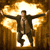 A pixelated figure in a brown jacket and dark pants stands with arms outstretched against a glowing golden background with white highlights.