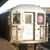 A subway train front with a pink circular symbol on the right side, displayed in four showing slight variations