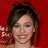 A pixelated image of a person with brown hair against a red background, showing two side-by-side views where the right view has brighter lighting and visible teeth.