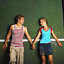 Static image of two people holding hands against a green background with white horizontal stripe.