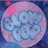 A static pixelated icon features a light blue floral design on a pink circular background with dark blue edges.