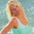 Static image of a person with long blonde hair in light blue clothing against a pixelated background, next to green text reading "Original Icons .com" on dark green.