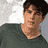 Static 48x48 pixel buddy icon showing a person with short dark hair wearing a dark green shirt against a light gray background.