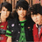 Three individuals in red and green clothing stand together under pink text reading Jonas Brothers, with additional pink text below stating ROCK MY WORLD!!! I LUV THEM!!! on a black background.