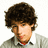 A pixelated image of a person with curly brown hair wearing a light gray shirt over a white collared shirt, next to cyan text on a blue background.