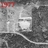A pixelated grayscale image with a red banner at the top, showing indistinct shapes and lines suggesting a blurred scene.